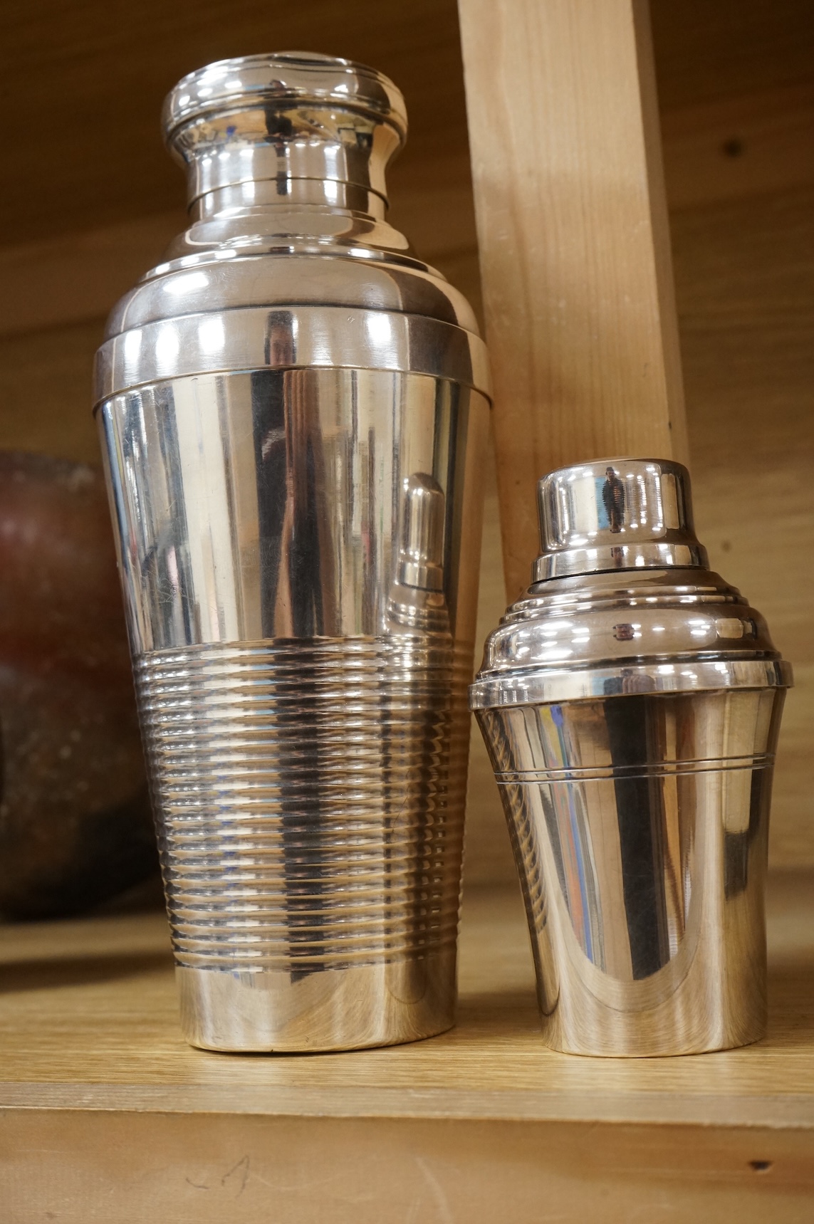 A small cocktail individual shaker and another larger example, 21cm high
